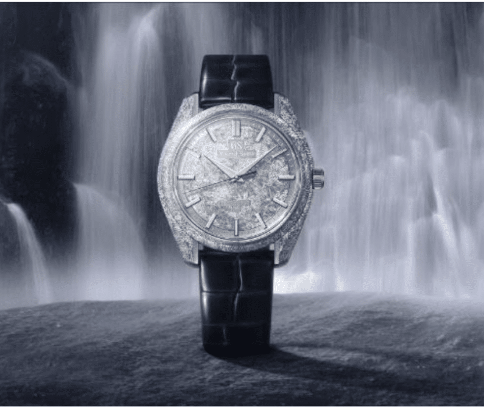 GRAND SEIKOCascada Mística SBGZ011LIFESTYLE Watches World Luxurious diamond encrusted wristwatch with a black strap set against a misty waterfall background