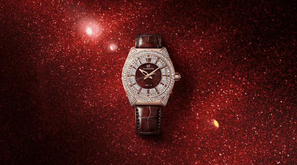 GRAND SEIKOMasterpiece Spring Drive León RojoLIFESTYLE Watches World Diamond encrusted luxury wristwatch with a burgundy dial and brown leather strap on a red glittery background