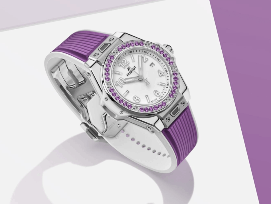 HUBLOTBig Bang Joyful Steel PurpleLIFESTYLE Watches World Hublot wristwatch with a white dial purple gemstone bezel and a purple rubber strap shown in an angled side view