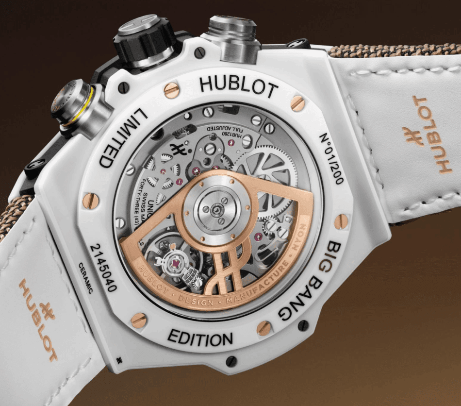 HUBLOTReloaded Kylian Mbappé White CeramicATRÁS Watches World White ceramic Hublot watch back with a transparent case reveals inner gears and a rose gold rotor 'HUBLOT' and 'EDITION' etched on bezel.