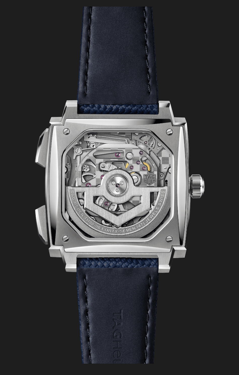 TAG Heuer Monaco Evergraph TH8000 up of a luxury squareback watch revealing its mechanical movement through a transparent case back dark blue strap Heuer Monaco Evergraph 2 Watches World TAG Heuer Monaco Evergraph TH80 00 up of a luxury square back watch revealing its mechanical movement through a transparent case back dark blue strap stainless steel watch with a transparent caseback showing the mechanical movement and a dark blue strap viewed from the rear