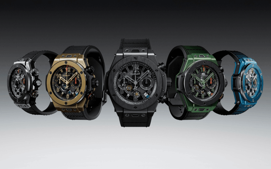 The Big Bang ReloadedLOS CINCO MODELOS Watches World Row of six luxury wristwatches Hublot with black gold gray green and blue straps displayed side by side on a gray gradient background