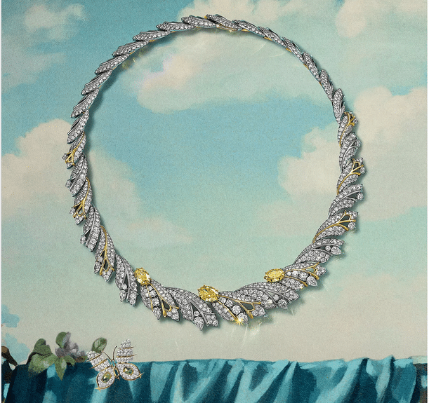 Tiffany Blue Book 2026 Hidden Garden Butterfly Watches World Collar circular con incrustaciones de diamantes y detalles en oro amarillo exhibido sobre un fondo de cielo en tonos pastel