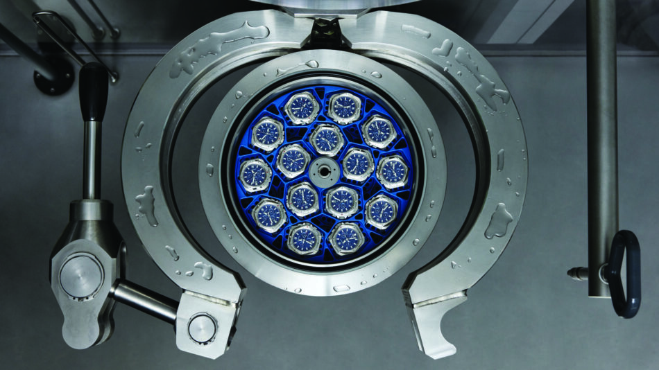 Centro de Competencia de Relojes de Victorinox 10 Watches World Industrial machine with a circular blue watch rack holding multiple blue faced watches inside a metal housing