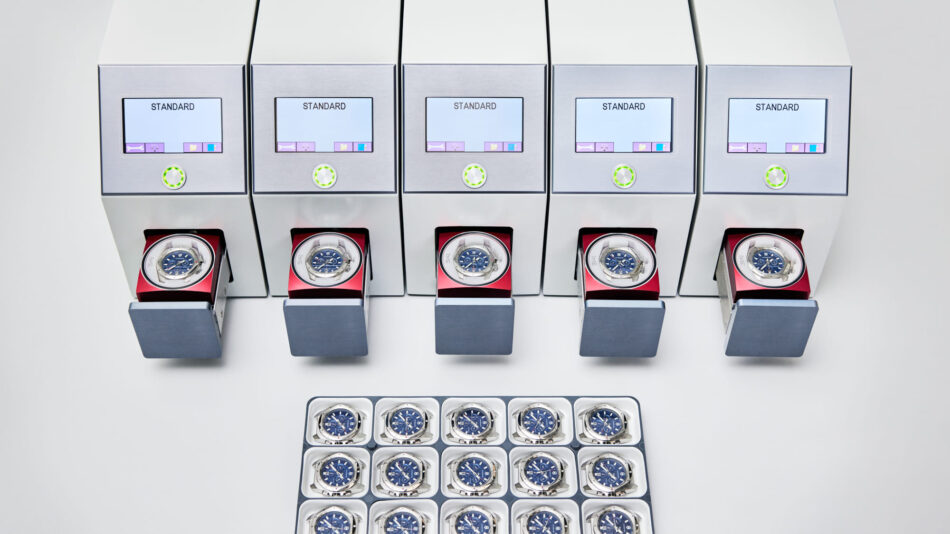 Centro de Competencia de Relojes de Victorinox 11 Watches World Row of metal watch display boxes with blue dial wristwatches arranged in two tiers on a light background