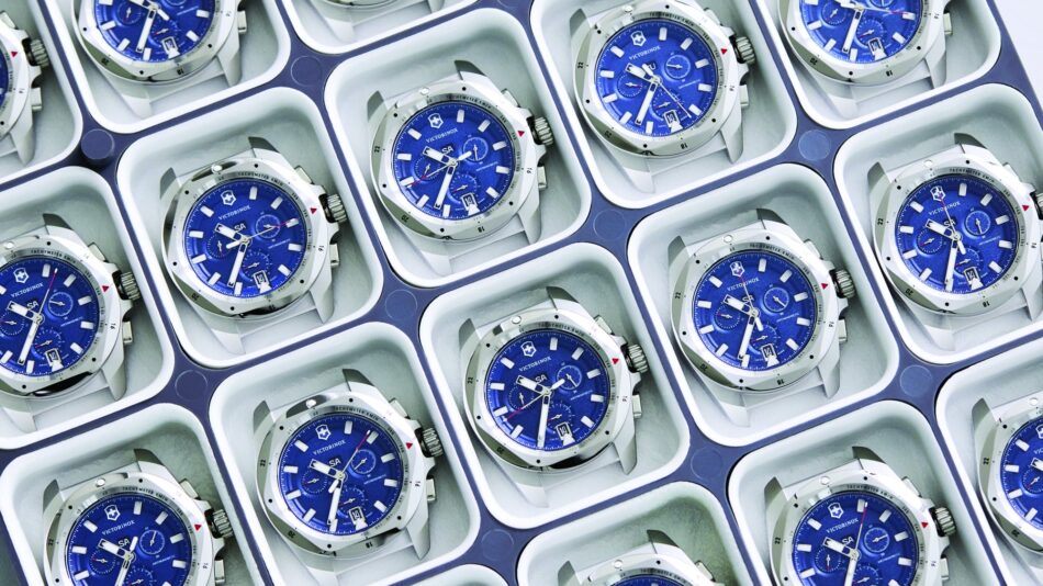 Centro de Competencia de Relojes de Victorinox 2 Watches World Multiple blue Victorinox wristwatches neatly arranged in individual display boxes forming a repeating grid