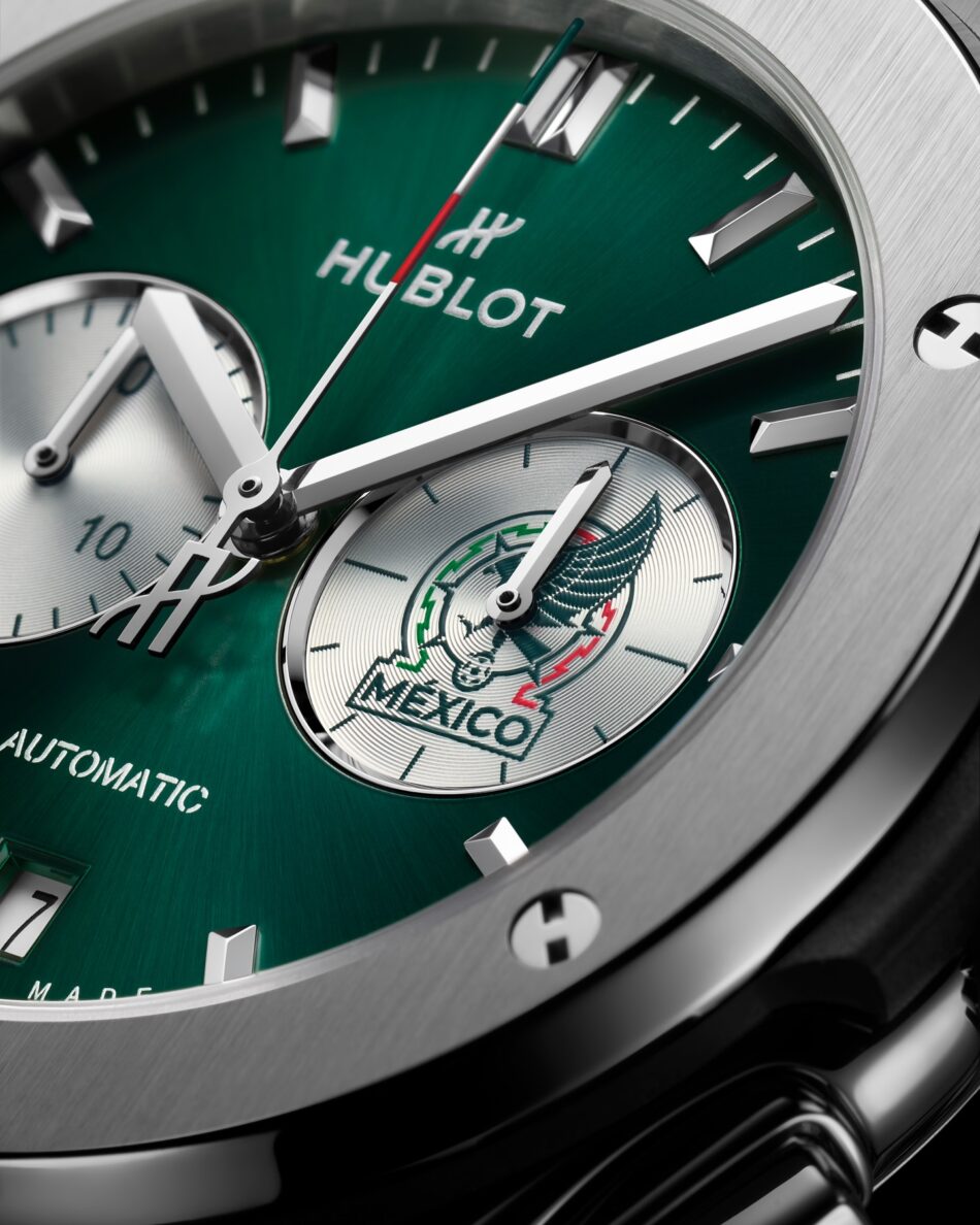 Hublot Classic Fusion Chronograph SNM Titanium 5 Watches World Hublot Classic Fusion Chronograph SNM Titanium 3 Close up of a stainless steel Hublot watch with green dial two subdials date window at 6 and green leather strap against a black background showcasing brushed bezel screwsClose up of a green Hublot watch dial with silver hands showing the brand name and a subdial featuring the Mexico emblem in metallic accents