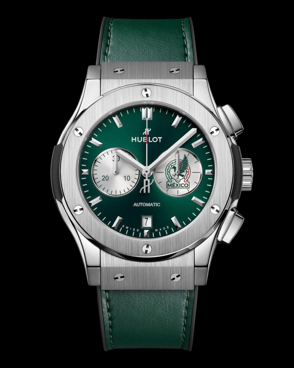 Hublot Classic Fusion Chronograph SNM Titanium Watches World Hublot Classic Fusion Chronograph SNM Titanium 3 Close up of a stainless steel Hublot watch with green dial two subdials date window at 6 and green leather strap against a black background showcasing brushed bezel screws