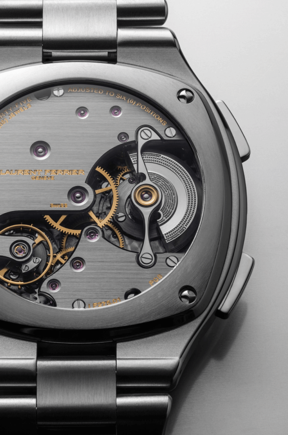 Laurent Ferrier Sport TravellerFONOD E CAJA Watches World Close up of a luxury watch movement with visible gears jewels and brushed metal case back