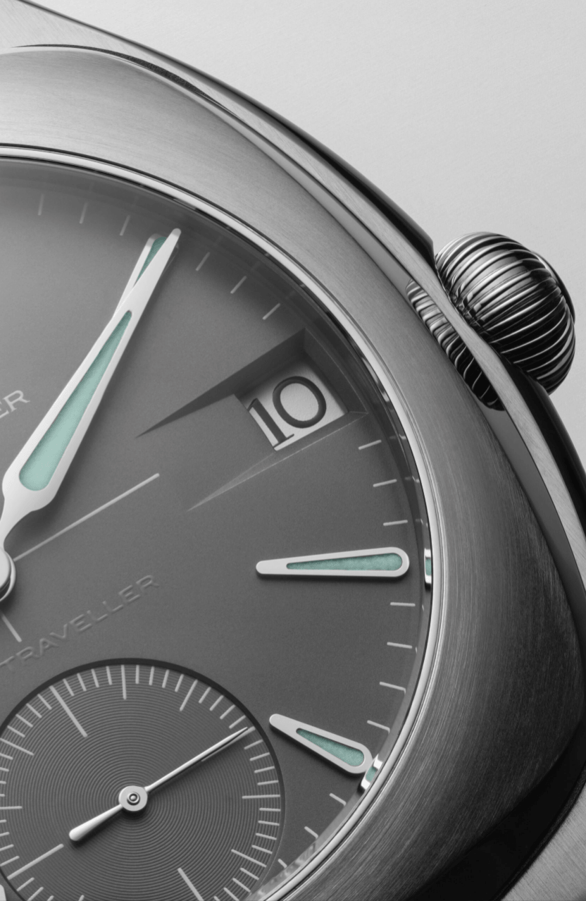 Laurent Ferrier Sport TravellerVENTANA DE FECHA Watches World Close up of a stainless steel wristwatch dial with teal accented hands and a date window displaying 10