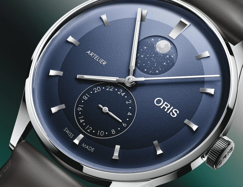ORIS ARTELIER COMPLICATION 22 Watches World Blue dial wristwatch showing moon phase at 1 oclock and a 24 hour subdial at 7 oclock brand ARTELIER and ORIS visible Swiss made