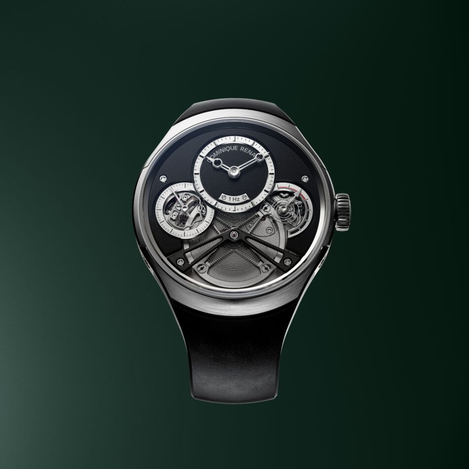 Pulse60PACKSHOT2 copia Watches World Close up of a luxury mechanical watch with exposed gears and a dark dial against a green background