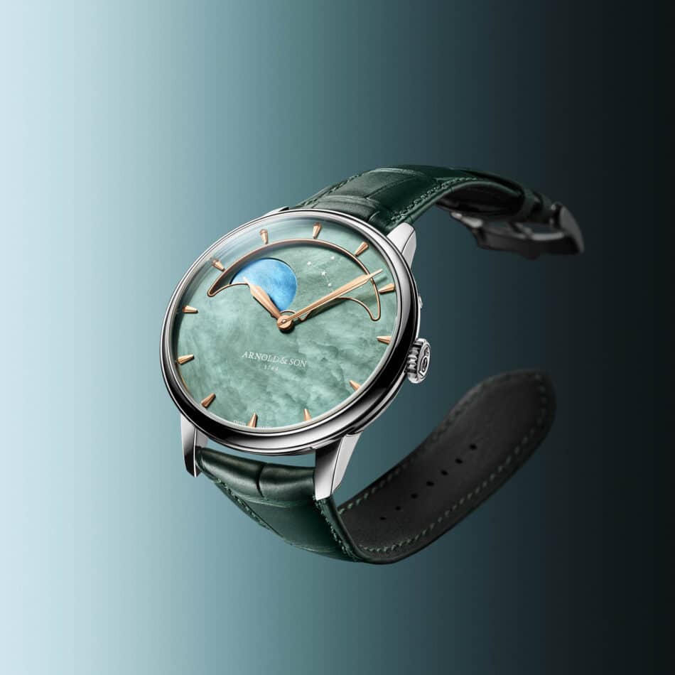 Stacked from 16 images Method=B R=8S=4 Watches World Close up of a green leather wrapped wristwatch with a blue green dial and gold markers against a gradient blue background