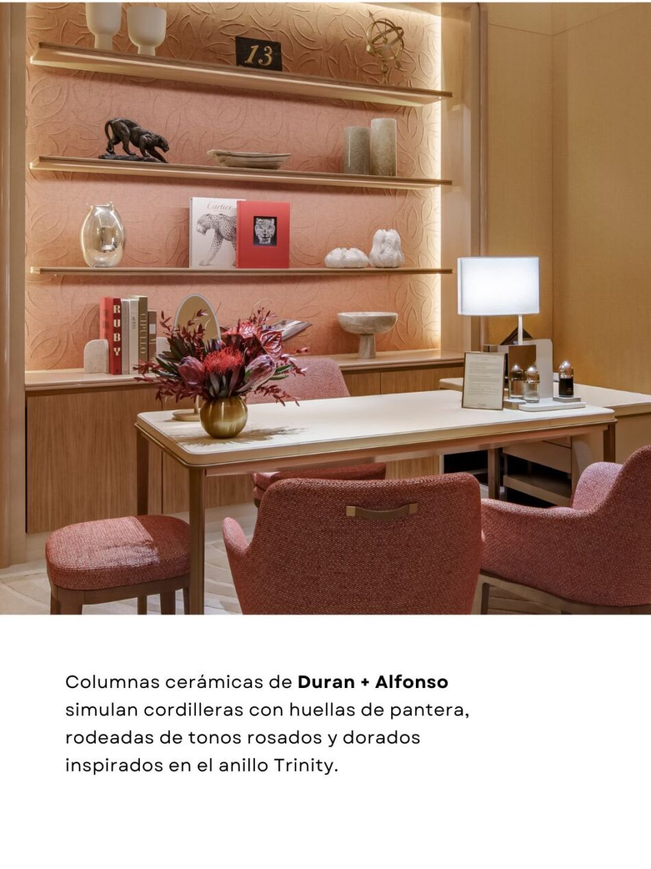 Boutique Cartier dentro de El Palacio de Hierro Monterrey5 Watches World Showroom seating area with pink upholstered chairs and a white table pink textured wall and gold shelves with decorative objects and a flower arrangement