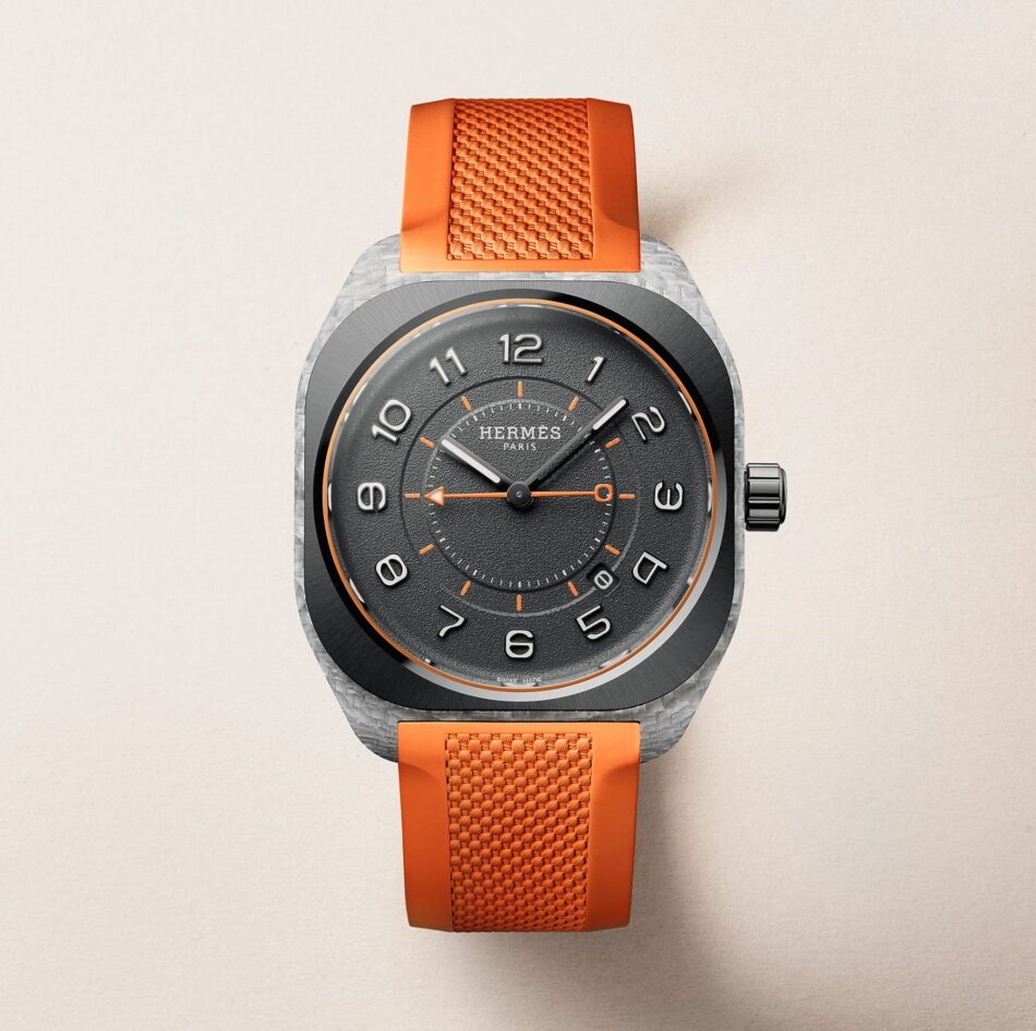 Hermès H08 1 Watches World Hermès H08 Close up of a Hermes Paris wristwatch with a dark dial orange accents and a bright orange textured strap