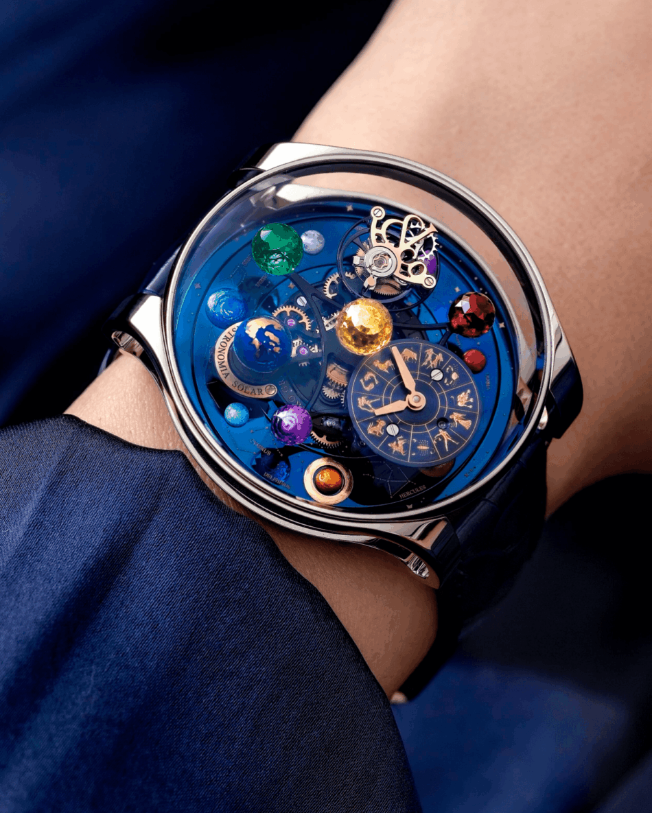 Jacob Co Astronomia Regulator Watches World Close up of a blue skeleton watch on a wrist showcasing colorful planetary spheres and intricate gears under a crystal face