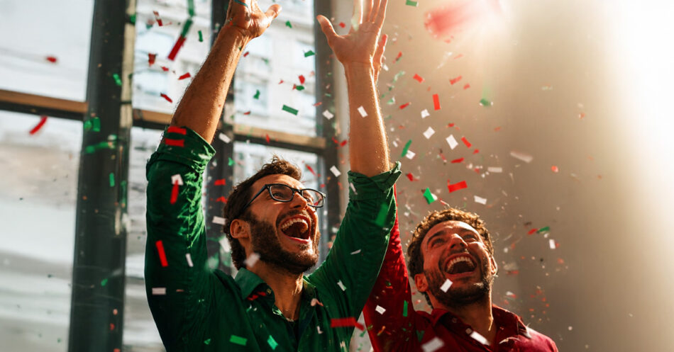 MIDO MTV MX03 Watches World MIDO MTV MX Two men in green and red shirts raise their arms in celebration as colorful confetti falls around them