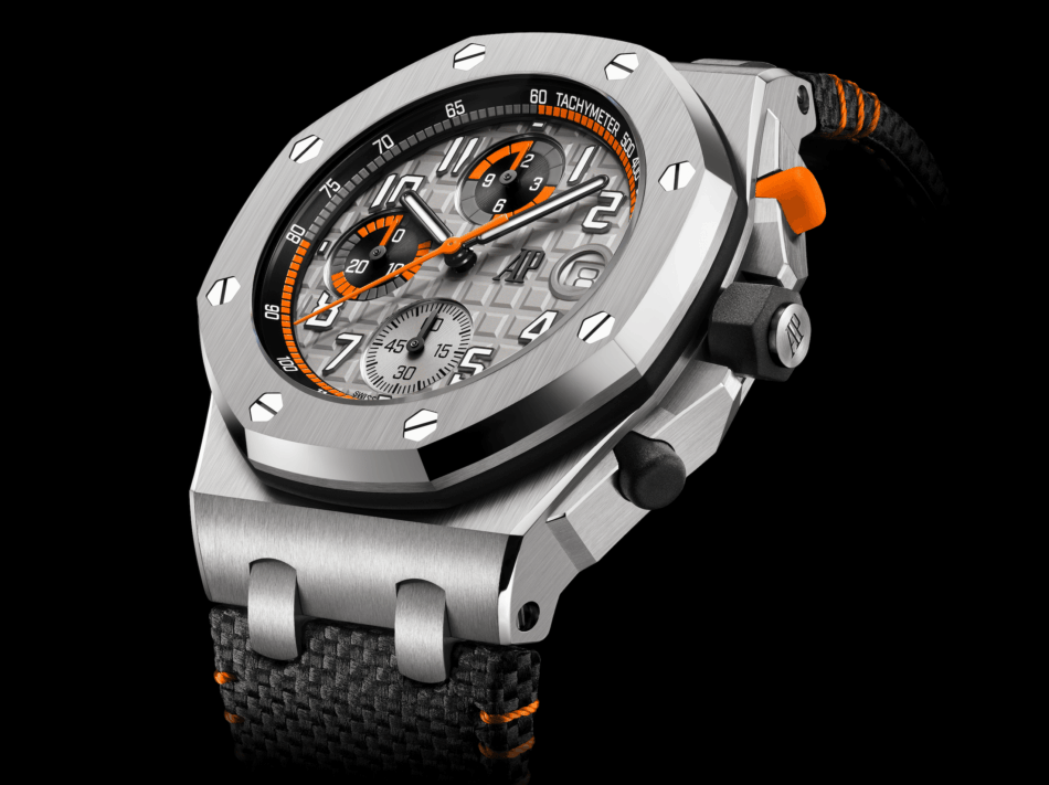 ROYAL OAK OFFSHORE case Watches World Close up of a stainless steel luxury watch with orange accents and a textured dial showing subdials and date window on a black background AP brand