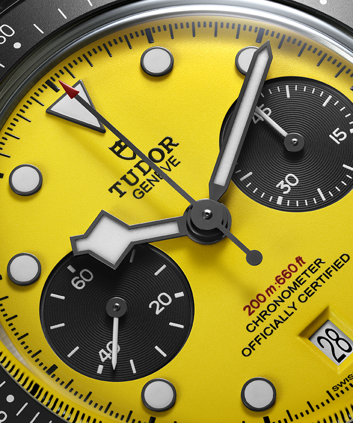Black Bay Chrono 39 Bumblebee TUDOR apuesta por el amarillo más atrevido Watches World Close up of a yellow Tudor chronograph watch dial with black subdials silver hands and a date window showing 28