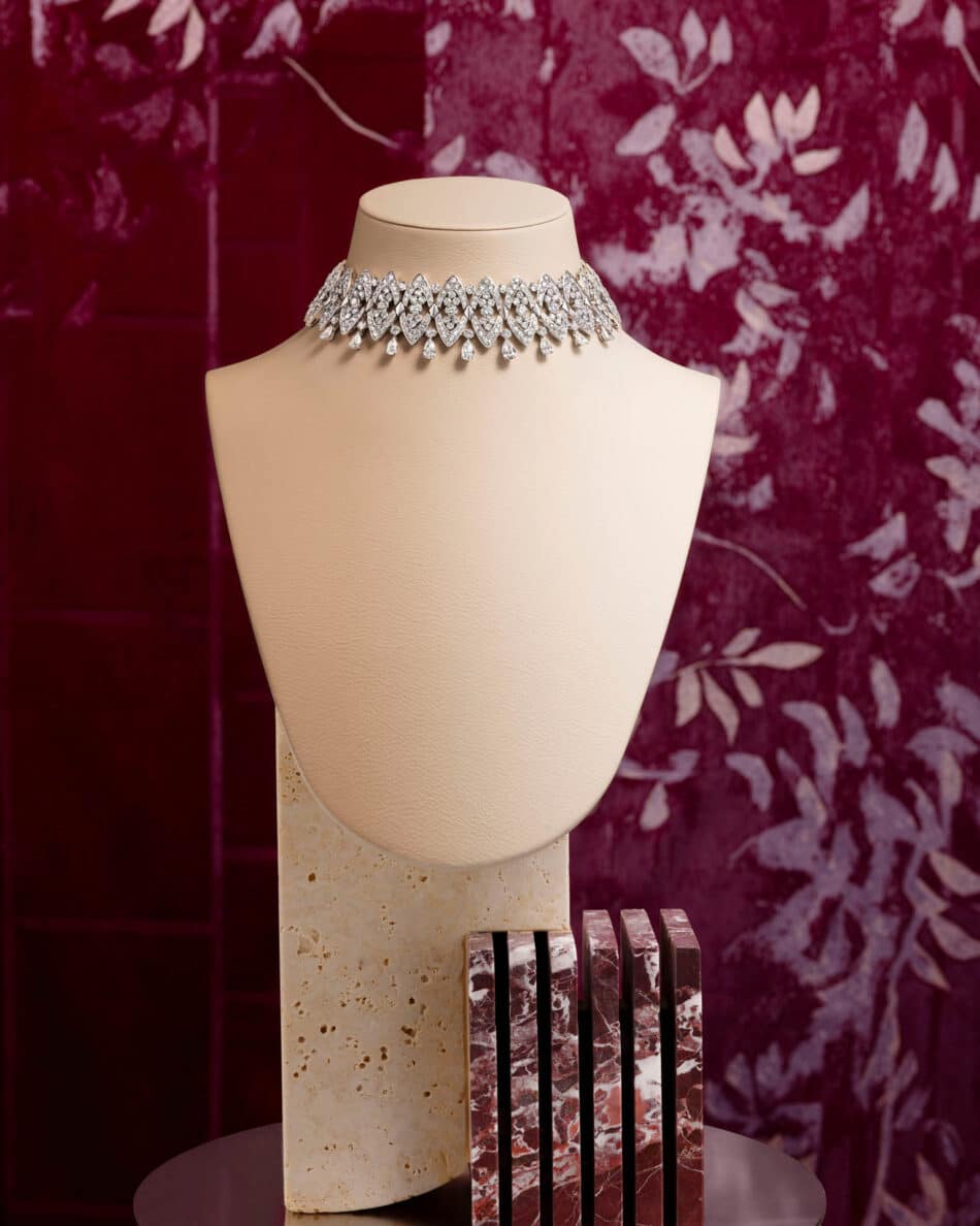 276605phAntonio Barrella4x5 Watches World Diamond choker necklace displayed on a beige bust with a burgundy floral backdrop