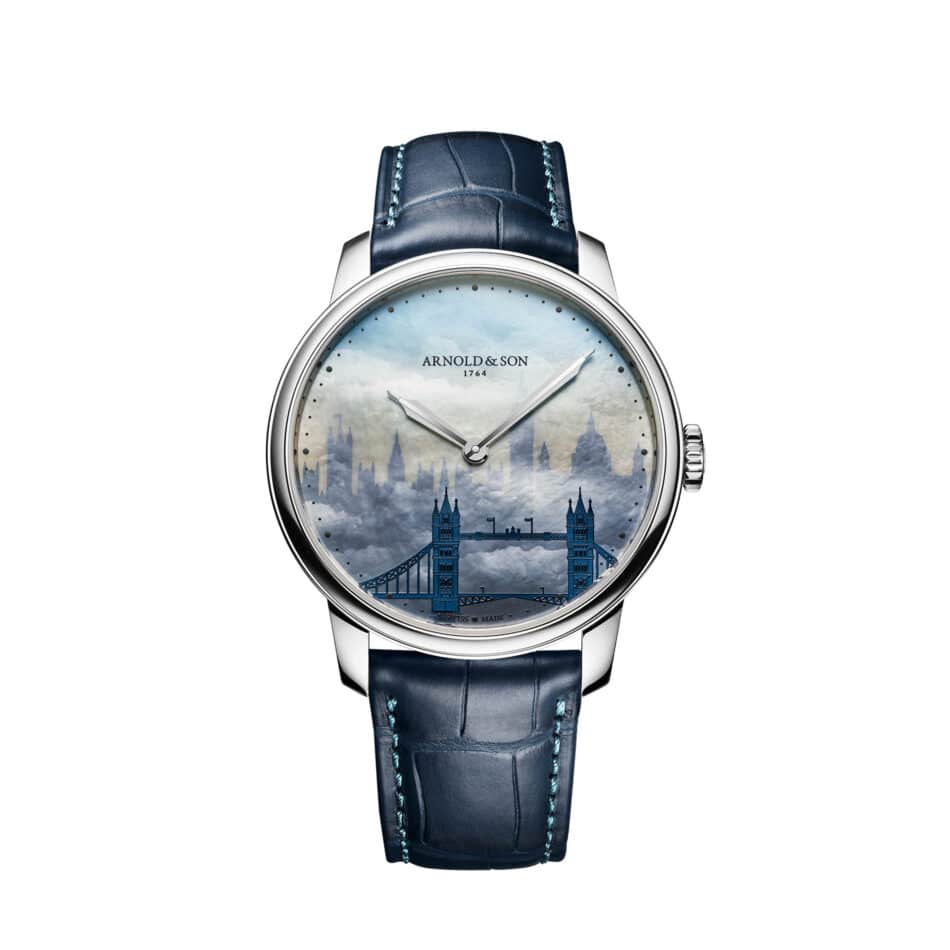 Arnold Son presenta HM London Skyline una obra de arte inspirada en la arquitectura de Londres Watches World Reloj de pulsera de Arnold Son con correa de piel azul y una esfera que presenta una ilustración del perfil urbano de una ciudad sobre un fondo de cielo nublado