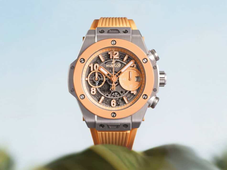 BIG BANG TITANIUM PEACH CERAMIC 1 Watches World Hublot wristwatch with an orange bezel skeleton dial and orange strap showing its gears and case screws