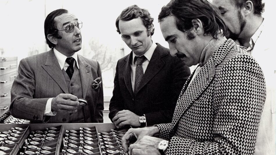 Ferrari TAG Heuer Nikki Lauda 2 Watches World Ferrari TAG Heuer Nikki Lauda Four men in vintage suits inspect sunglasses displayed in a retail case on a store counter