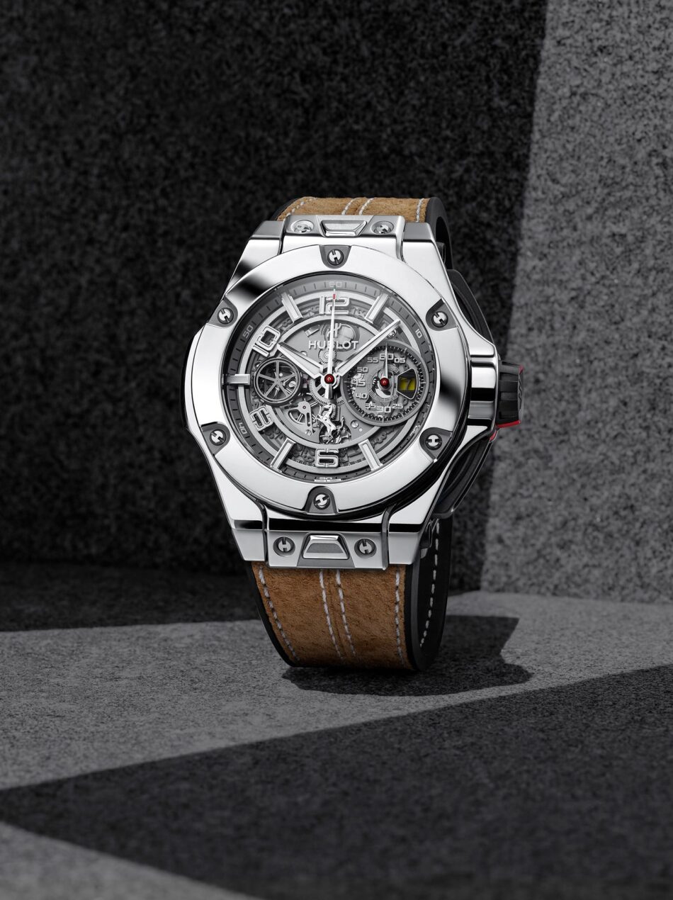 Hublot Ferrari 2 Watches World Hublot Ferrari Close up of a stainless steel luxury watch with a skeleton dial and brown leather strap on a dark textured background