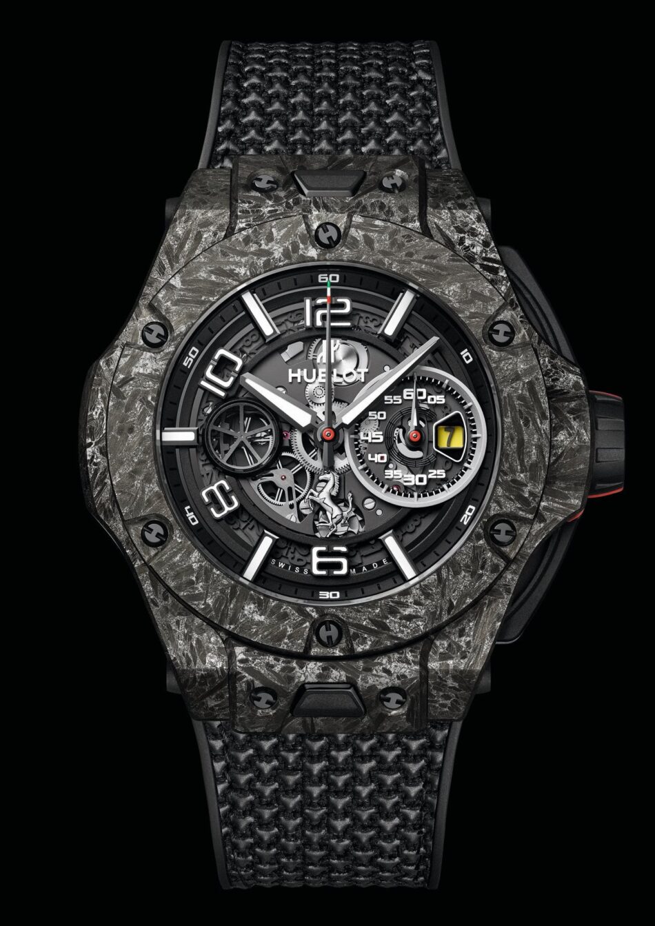Hublot Ferrari Watches World Hublot Ferrari Close up of a black textured carbon fiber watch with a skeleton dial and red accents Hublot