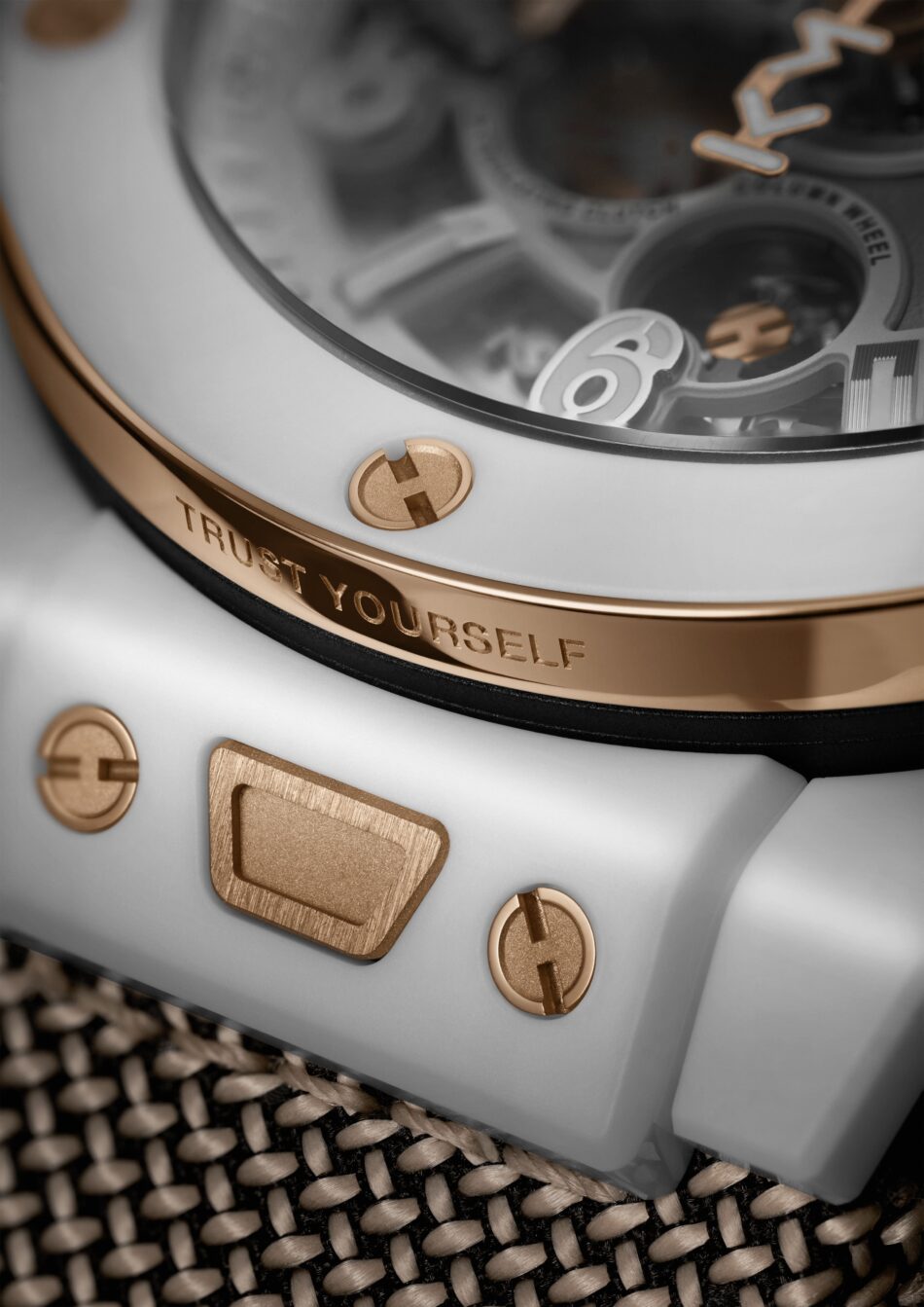 HublotBig Bang Reloaded Kylian Mbappé 5 Watches World Close up of a luxury watch with rose gold screws and a beveled bezel engraved phrase'Trust Yourself' visible on the band.