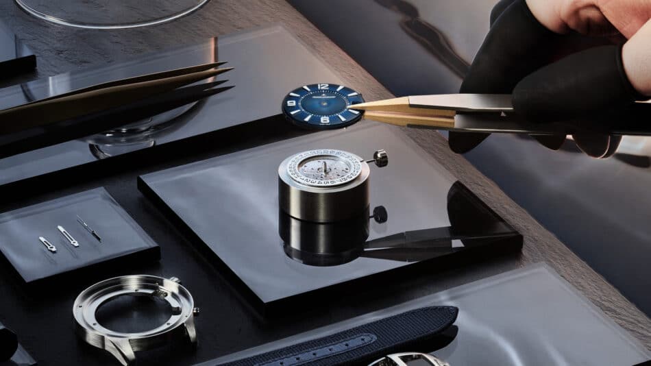 JaegerLeCoultre Polaris Date 40 mm el reloj deportivo que apuesta por la elegancia cotidiana Watches World Close up of a watchmaking workspace a blue dial rests on a glossy surface beside precision tweezers and watch components