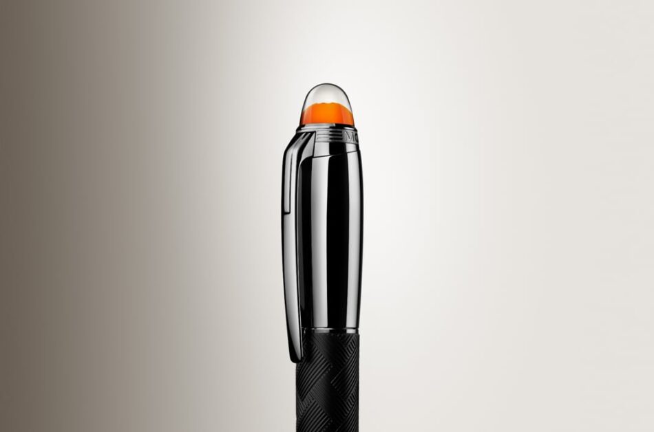 Montblanc StarWalker Extreme 1 Watches World Montblanc StarWalker Extreme Three black pens with orange tipped caps standing upright on a light beige background