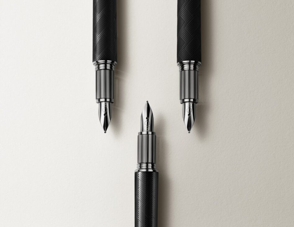 Montblanc StarWalker Extreme 2 Watches World Montblanc StarWalker Extreme Three black pens with orange tipped caps standing upright on a light beige background