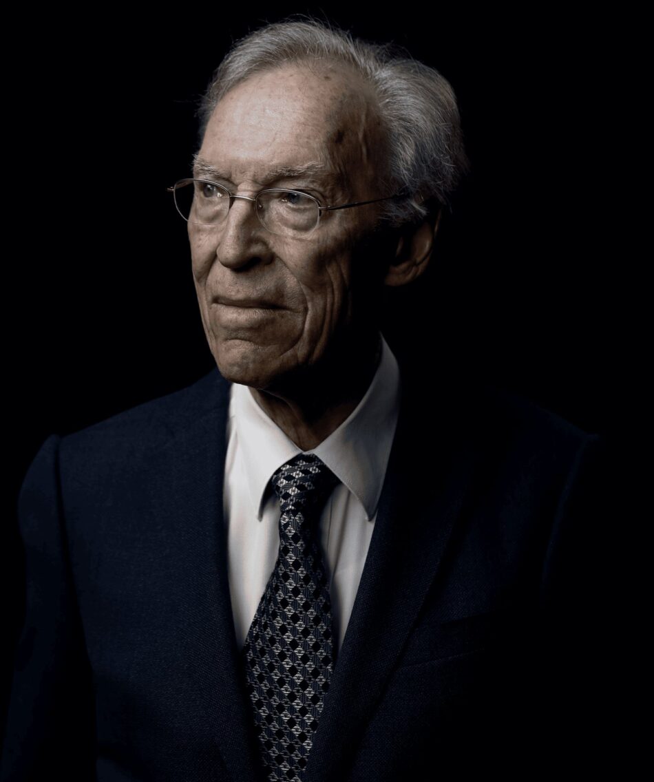 Oris Star y Dr Portmann 7 Watches World Oris Star y Dr Portmann Portrait of an older man wearing round glasses a dark suit and patterned tie against a black background