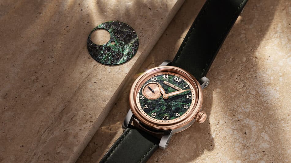 Chronoswiss Small Second Serpentine Case Watches World Rose gold wristwatch with a green marbled dial and black leather strap on a beige stone surface