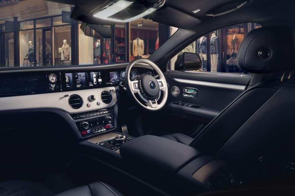 RollsRoyce Ghost Savile Row 2 Watches World Rolls Royce Ghost Savile Row 2 Interior of a luxury car with a digital instrument cluster and Premium center console storefronts visible through the windows outside the car