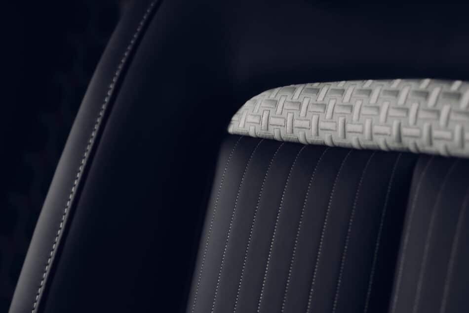 RollsRoyce Ghost Savile Row 7 Watches World Rolls Royce Ghost Savile Row Close up of a dark car seat with a light gray woven pattern cushion and white contrast stitching